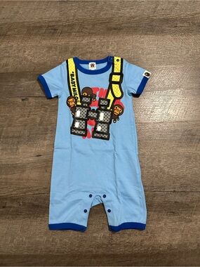 BAPE Light Blue Baby Milo Graphic Romper with Yellow Strap Print